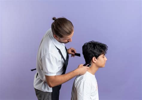 Free Photo Young Handsome Barber Wearing Uniform Standing In Profile