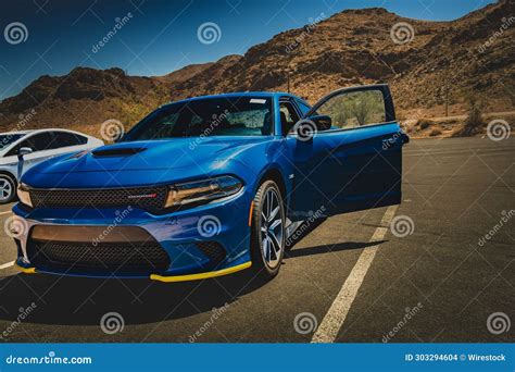 Two Cars In A Parking Lot And Mountains In The Background Editorial