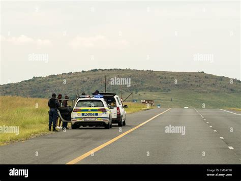 South African Policemen In A Saps Vehicle On The Shoulder Of The