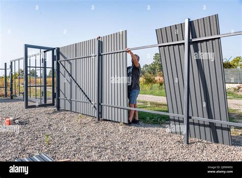 Installation of metal gates Stock Photo - Alamy