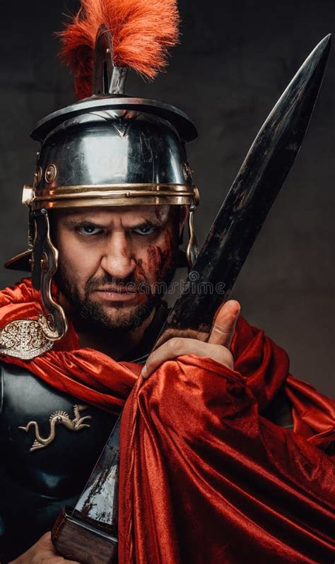 Angry Roman Warrior Staing At Camera In Dark Background Stock Photo