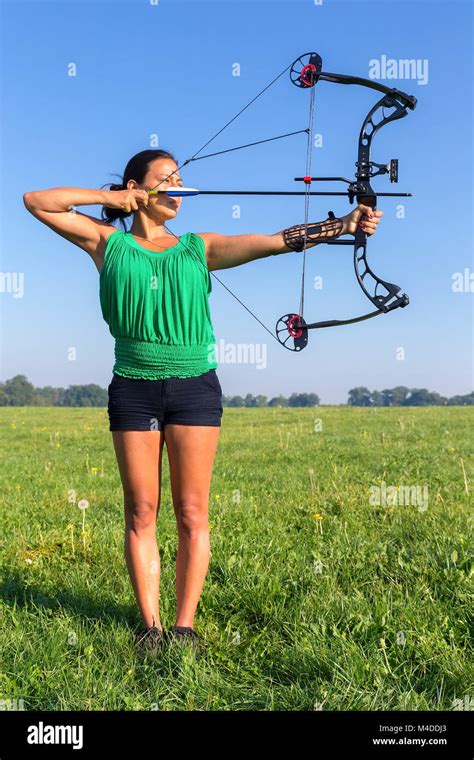 Young Woman Shooting Arrow Of Compound Bow Stock Photo Alamy