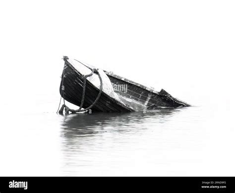 A small boat sinking, mono black and white, in river Stock Photo - Alamy