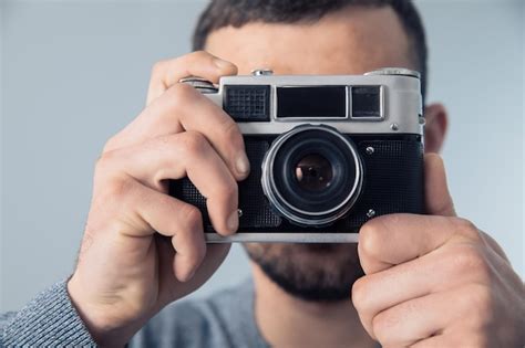 Premium Photo | Man holding vintage camera