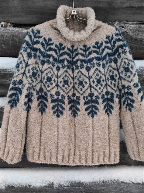 A Sweater Hanging On A Clothesline With Snow Around It And Wood In The