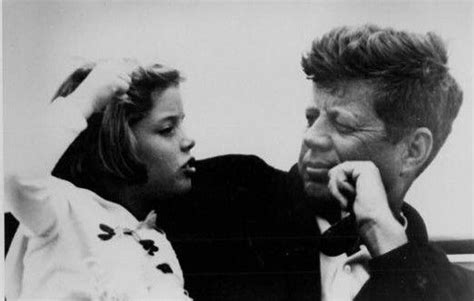 an old black and white photo of a man talking on the phone to a woman