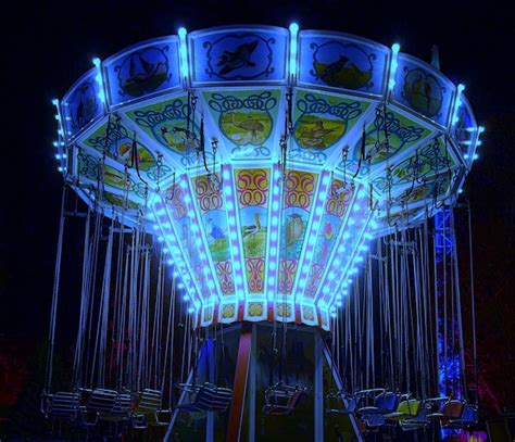 Premium Photo Illuminated Chain Swing Ride At Amusement Park