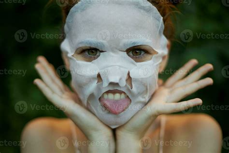 Beautiful Woman Face Mask Shows Tongue And Holds Hands Near Face