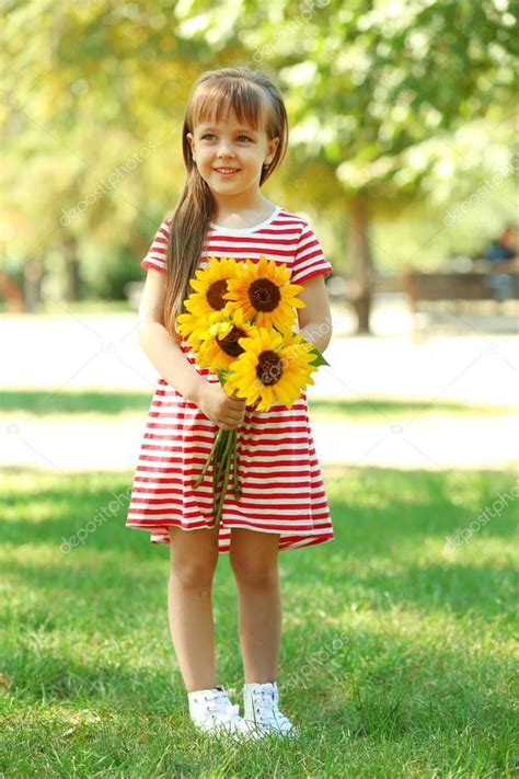 Little girl with sunflowers Stock Photo by ©belchonock 95294250