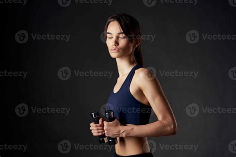 Pretty Brunette With Dumbbells In Her Hands Slim Figure Gym Fitness Stock Photo At Vecteezy