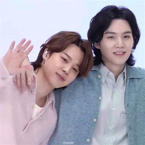two people are posing for the camera with their hands on each other's ...