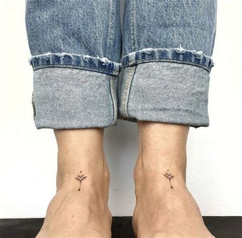 Two Feet With Small Tattoos On Them