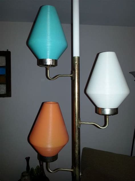 three different colored lamps are hanging on the wall next to each other in a living room