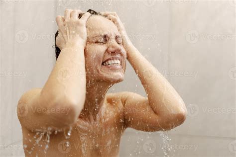 Naked Brunette Woman Screaming In The Shower Under Cold Water Jet Stock Photo At Vecteezy