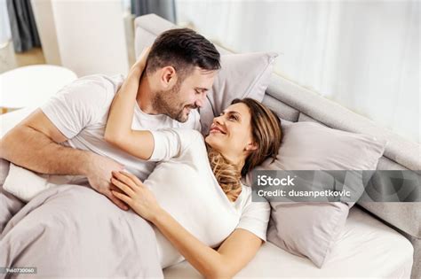 A Romantic Couple Is Cuddling In Bed In The Morning Stock Photo ...