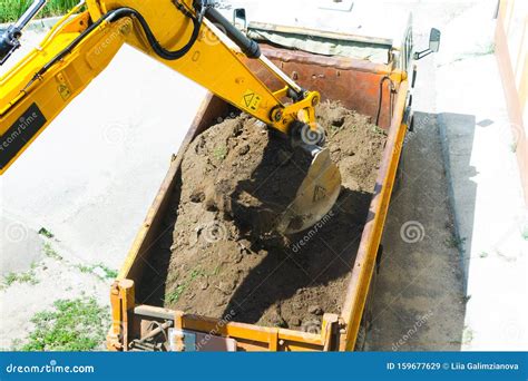 Excavator Is Loading Excavation To The Truck Stock Image Image Of