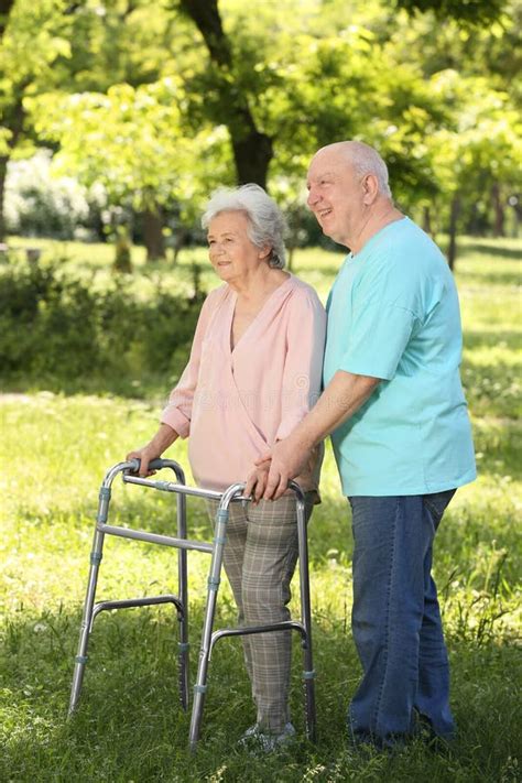 Elderly Man Helping His Wife With Walking Frame Stock Image Image Of