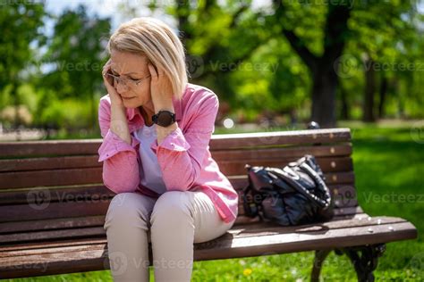 Portrait Of Mature Woman In Park She Is Worried And Depressed Stock Photo At Vecteezy