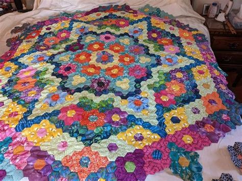 Colorful Hexagon Quilt On Bed