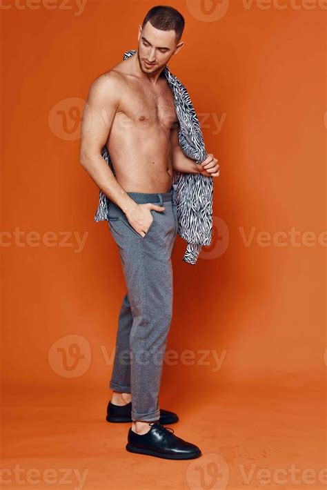 Handsome Man In Shirt Nude Torso Posing Fashion Orange Background 22004627 Stock Photo At Vecteezy