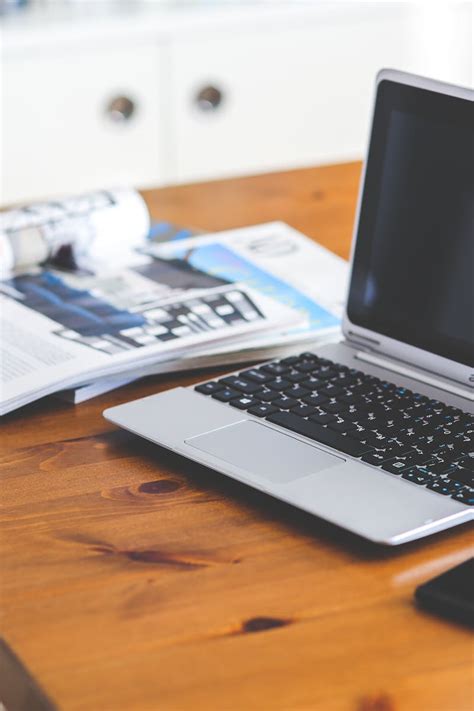 Laptop And Cell Phone On A Wooden Desk · Free Stock Photo