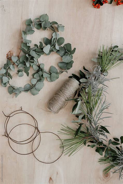 Making A Christmas Wreath With Branches And Leaves By Stocksy