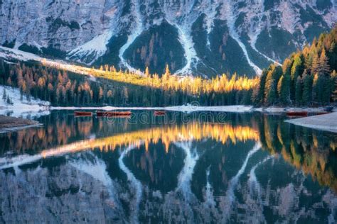 Braies Lake with Reflection in Water at Sunrise in Autumn Stock Photo ...