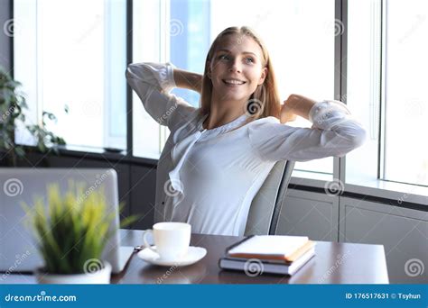 Business Woman Is Relaxing With Her Hands Behind Her Head And Sitting