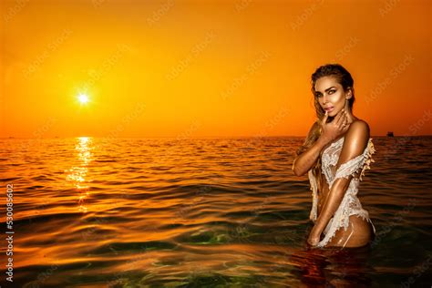 Sexy Woman In Bikini Is Posing In Ocean On Sunset On The Maldives Island Romantic Scenery Of