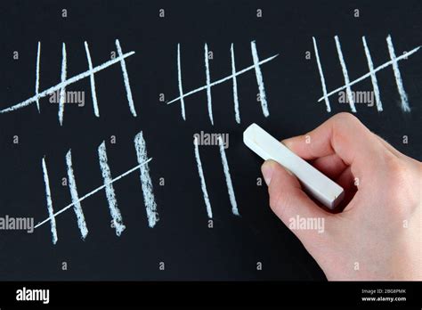 Counting Days By Drawing Sticks On Black Background Stock Photo Alamy