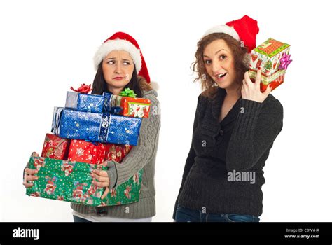 Funny two women holding Christmas gifts isolated on white background Stock Photo - Alamy