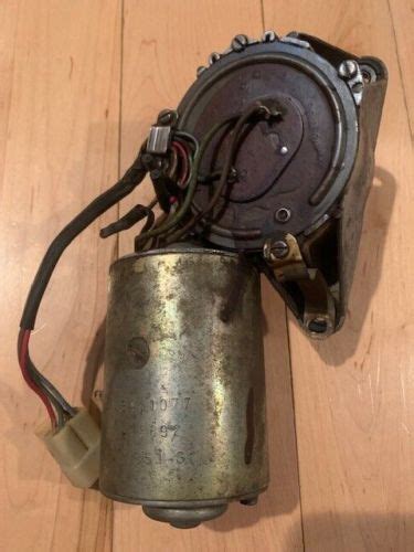 An Old Motor Sitting On Top Of A Wooden Floor With Wires Attached To