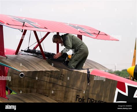 Pilot enters cockpit of A replica ww1 Fokker Triplane triplane aircraft, at Breighton general ...