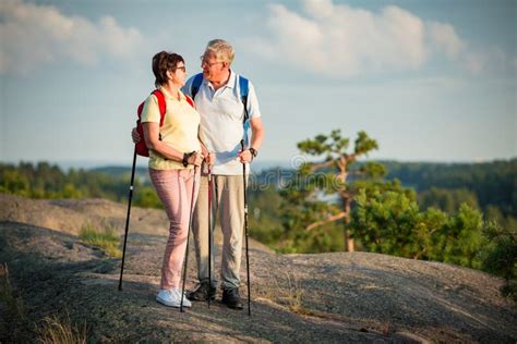 Active Senior Couple Hiking On The Top Of Rock Stock Image Image Of