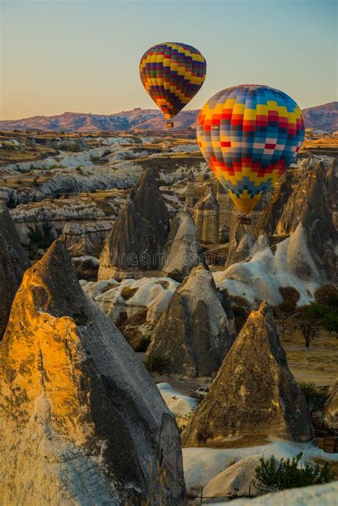 Hot Air Balloons at Sunrise Flying Over Cappadocia, Turkey. a Balloon ...