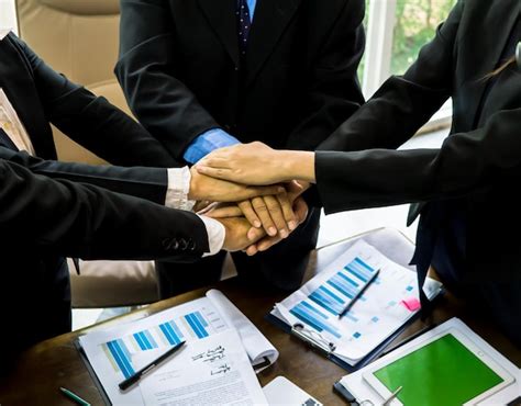 Premium Photo Midsection Of Business People Stacking Hands At Table