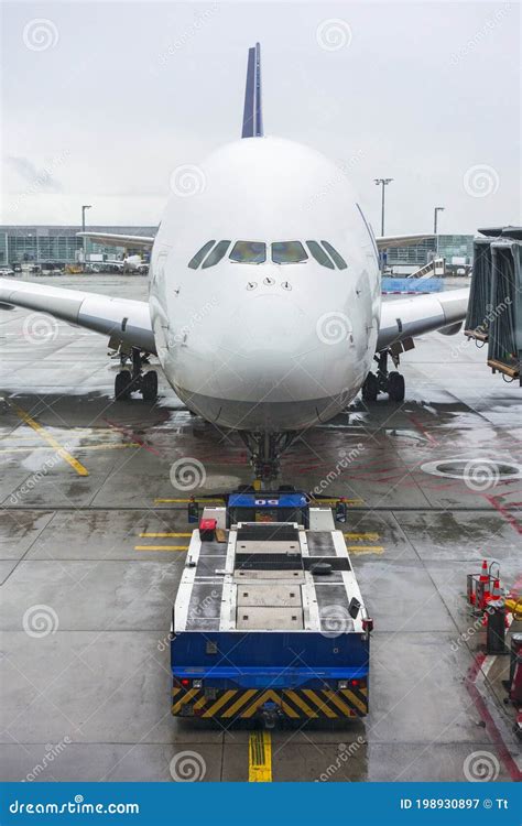 Pushback Tug and a Large Airplane at an Airport Stock Image - Image of ...