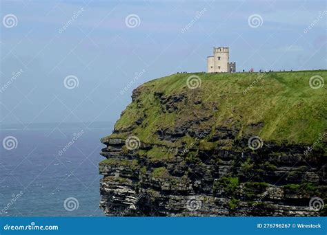 stone tower   green cliff   background   sky cliffs