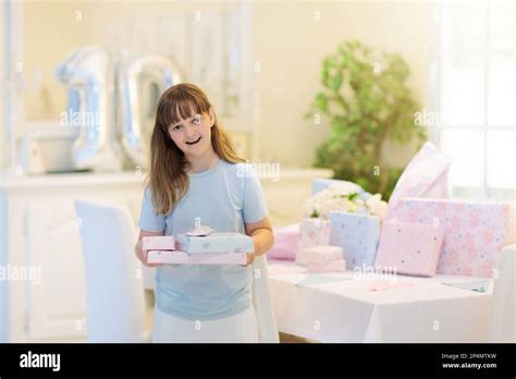 Kids birthday party. Child blowing out candles on colorful cake. Little ...