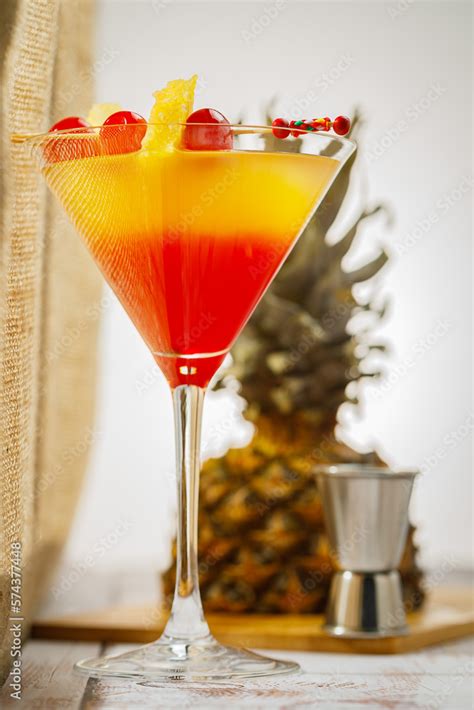 Bikini Martini Cocktail In Martini Glass Garnished With Cherries And Pineapple Martini