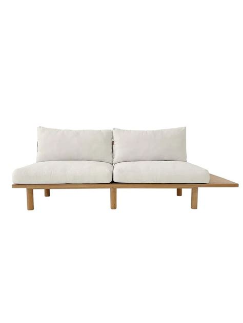 A White Couch Sitting On Top Of A Wooden Table