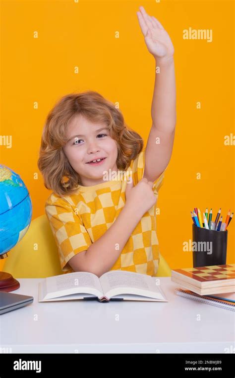 Schoolchildren Raising Hands In Class Hi Res Stock Photography And