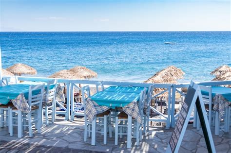 Premium Photo | Restaurant terrace in front of the beach in kamari on ...