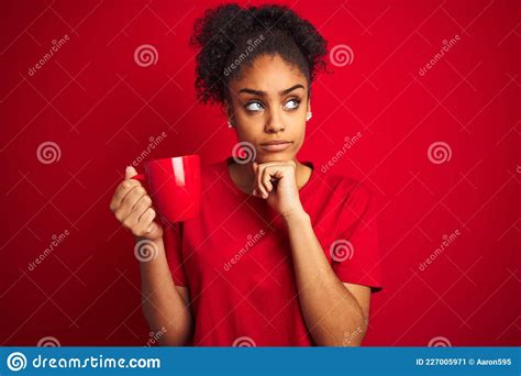 Young African American Woman Drinking A Cup Of Coffee Over Isolated Red