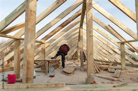 We install roof rafters on a new building. Stock Photo | Adobe Stock