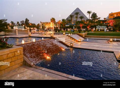 Evening Or Night Time View Of The Mena House Hotel With The Pyramids In The Background Giza