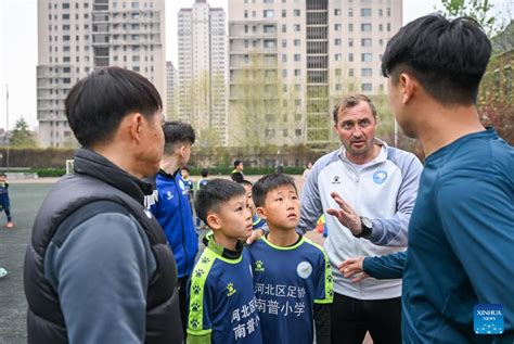 Foreign Football Coaches Give Instructions To Young Football Players In