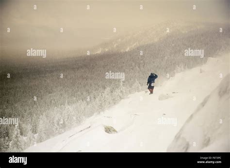 Caucasian Hiker Waking On Snowy Hillside Stock Photo Alamy