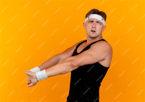 Free Photo Confused Young Handsome Sporty Man Wearing Headband And