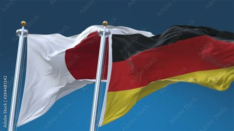 4k Seamless Germany And Japan Flags With Blue Sky Background A Fully